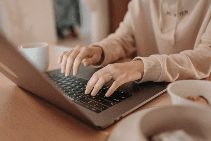 Hands typing on a keyboard.